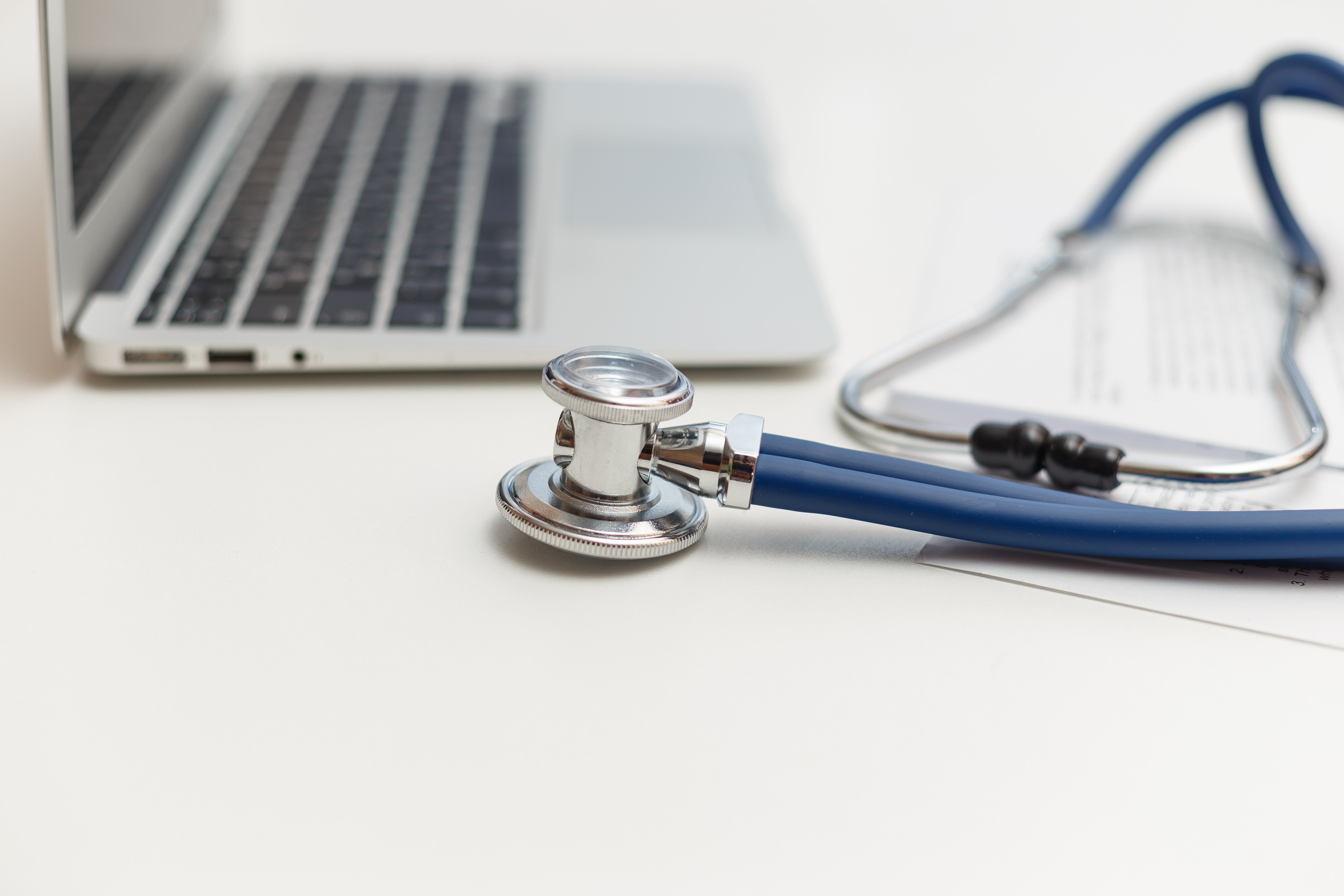stethoscope-and-laptop-on-doctor-working-desk-PMJD39Z